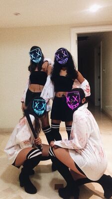 4 girls wearing led masks